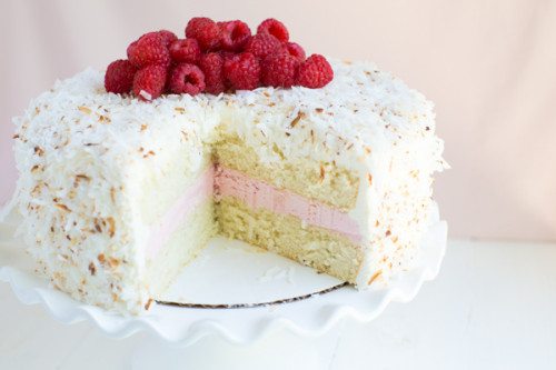 Coconut Cake with Raspberry Buttercream Filling and Coconut Marshmallow Frosting is an impressive dessert that everyone will love!