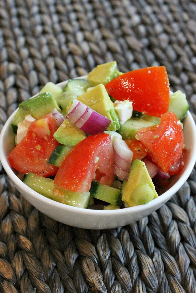 Avocado, Cucumber, Tomato Salad recipe from RecipeGirl.com #avocado #cucumber #tomato #salad #recipe #RecipeGirl serving of avocado cucumber tomato salad in a white bowl