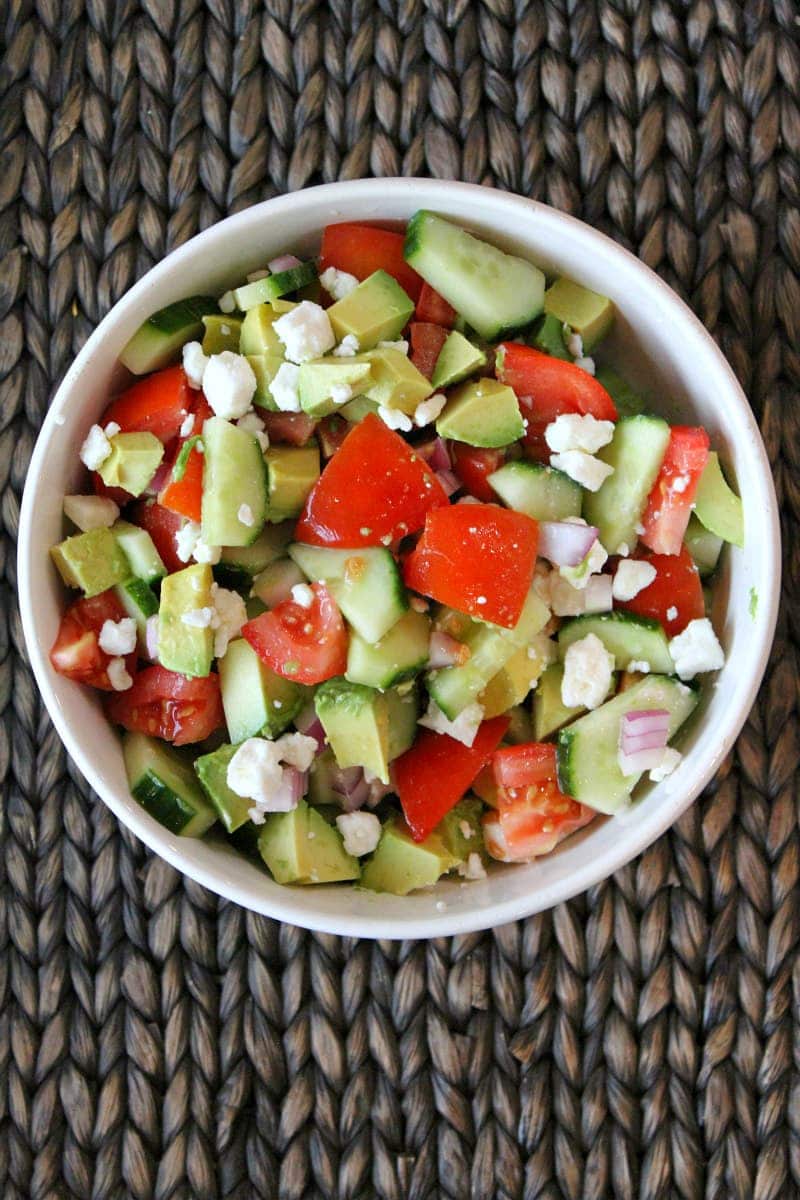 Avocado, Cucumber, Tomato Salad recipe from RecipeGirl.com #avocado #cucumber #tomato #salad #recipe #RecipeGirl Overhead shot of avocado cucumber tomato salad in a white bowl