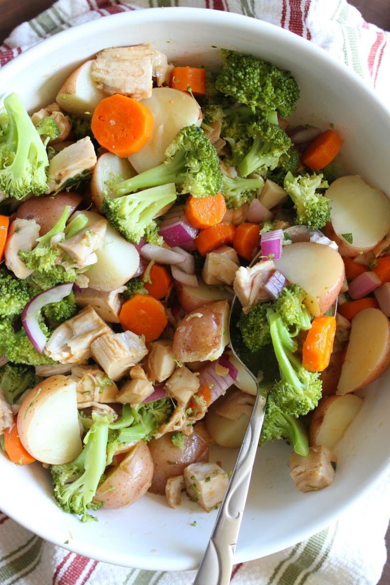 Broccoli and Chicken Salad with Lemon Dressing recipe from RecipeGirl.com #broccoli #chicken #salad #lemon #dressing #recipe #RecipeGirl Broccoli and Chicken Salad with Lemon Dressing in white bowl with spoon