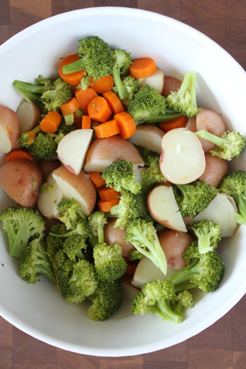 Making Broccoli and Chicken Salad in white bowl