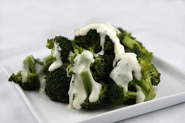 Fresh steamed broccoli topped with a Parmesan and Swiss cheese sauce