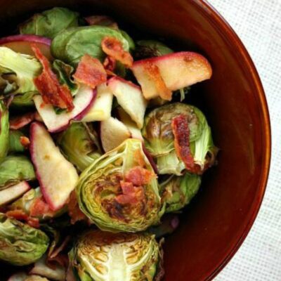Brussels sprouts with bacon and apple in a bowl