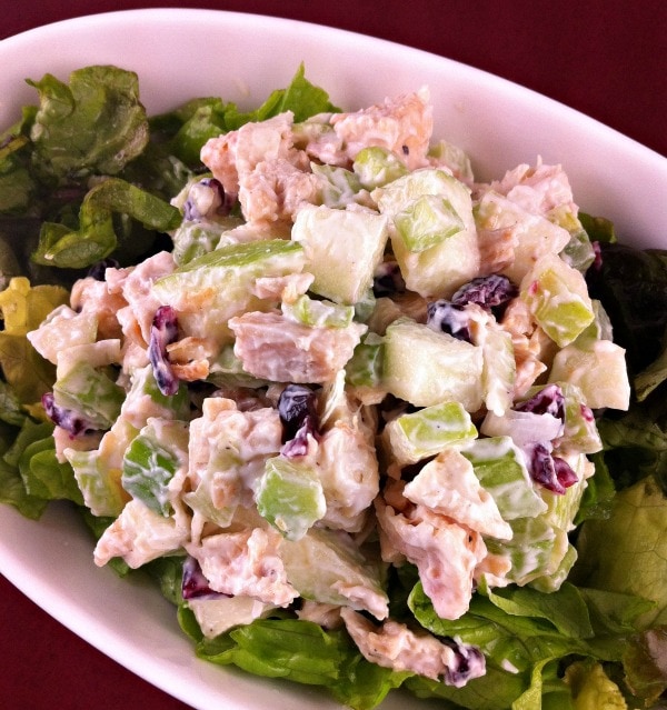 Chicken Apple Crunch Salad over lettuce leaves in white bowl