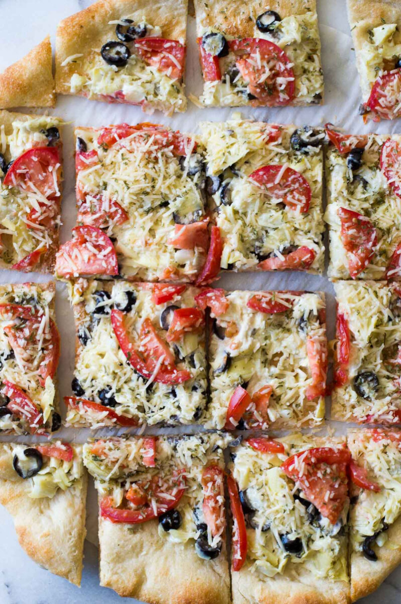 Artichoke Pizza Bites appetizer recipe from RecipeGirl.com #artichoke #pizza #bites #appetizer #pamperedchef #recipe #RecipeGirl overhead shot of artichoke pizza cut into pieces