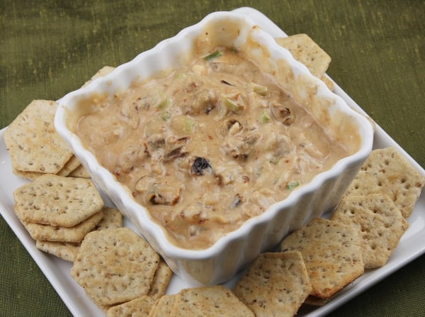 Asiago Cheese Dip in a white dish with crackers