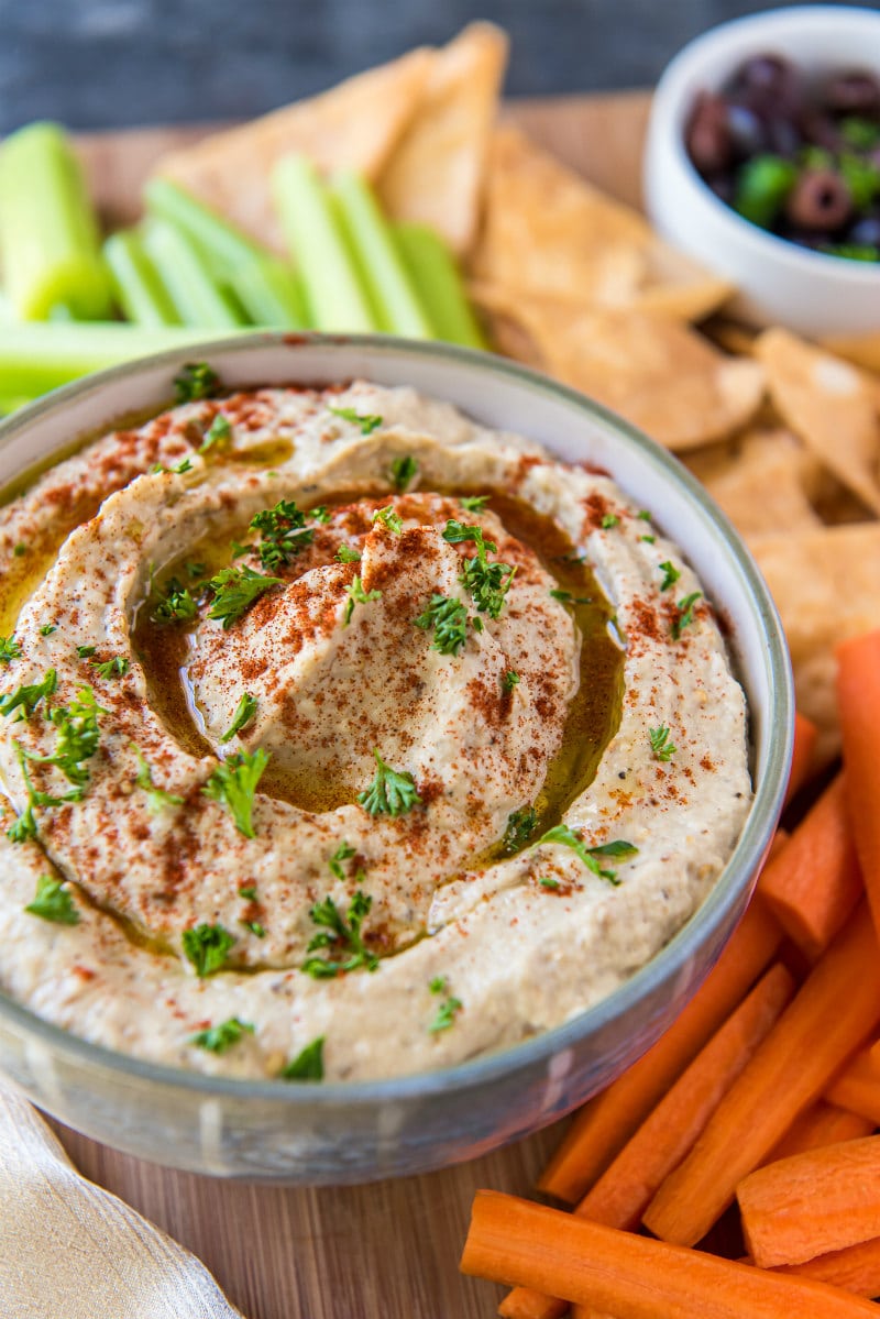 bowl of Baba Ghanoush served with carrots, celery and pita chips