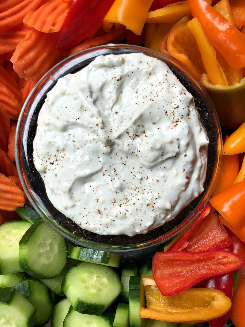 overhead shot of blue cheese dip served with cucumbers, carrots and bell pepper