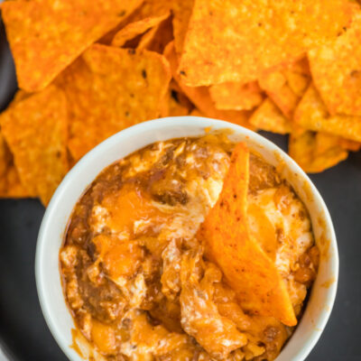 chili cheese dip in a bowl with chips