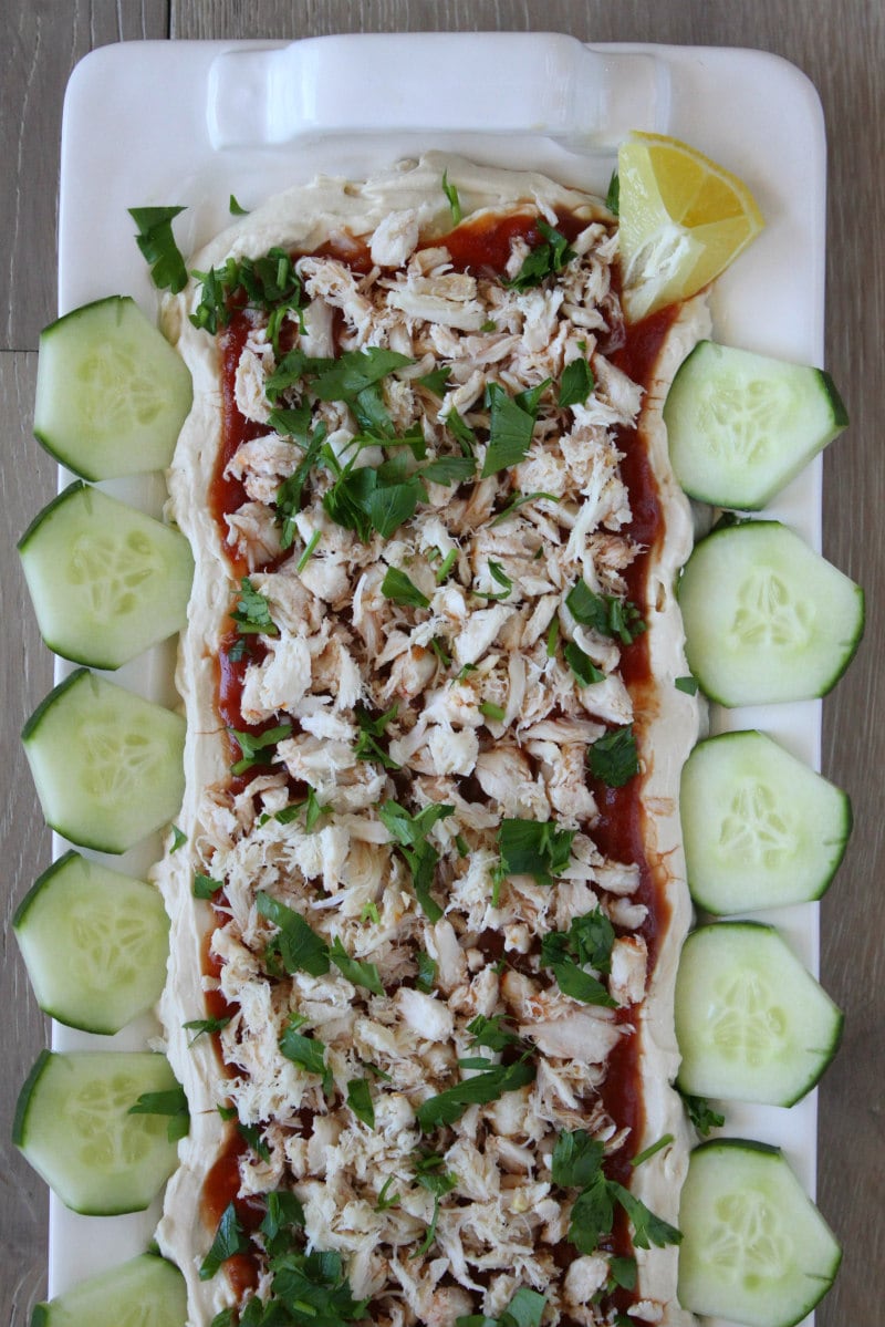 Crab spread appetizer recipe from RecipeGirl.com #crab #spread #appetizer #dip #party #entertaining #recipe #RecipeGirl Overhead shot of Crab Spread Appetizer on a platter surrounded by sliced cucumber