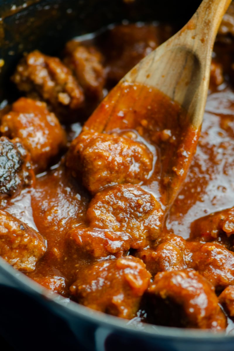 cooking cranberry meatballs in a pan