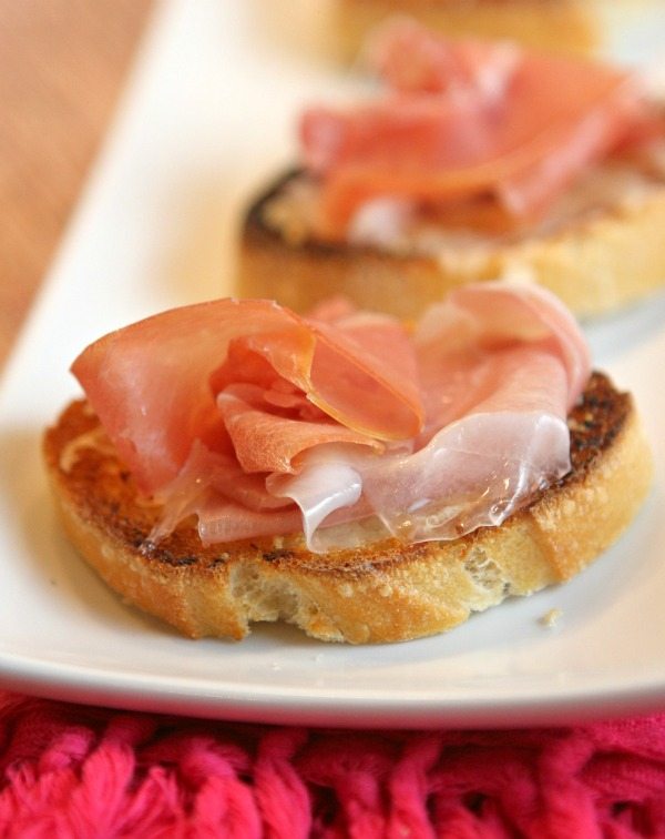 Cheese Crostini with Prosciutto recipe from RecipeGirl.com #cheese #prosciutto #crostini #appetizer #recipe #RecipeGirl Cheese Crostini with Prosciutto on a plate