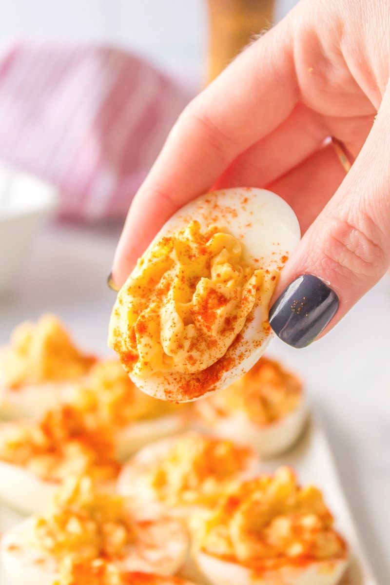 hand picking up deviled egg