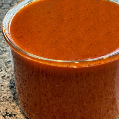 Enchilada sauce in glass jar on counter