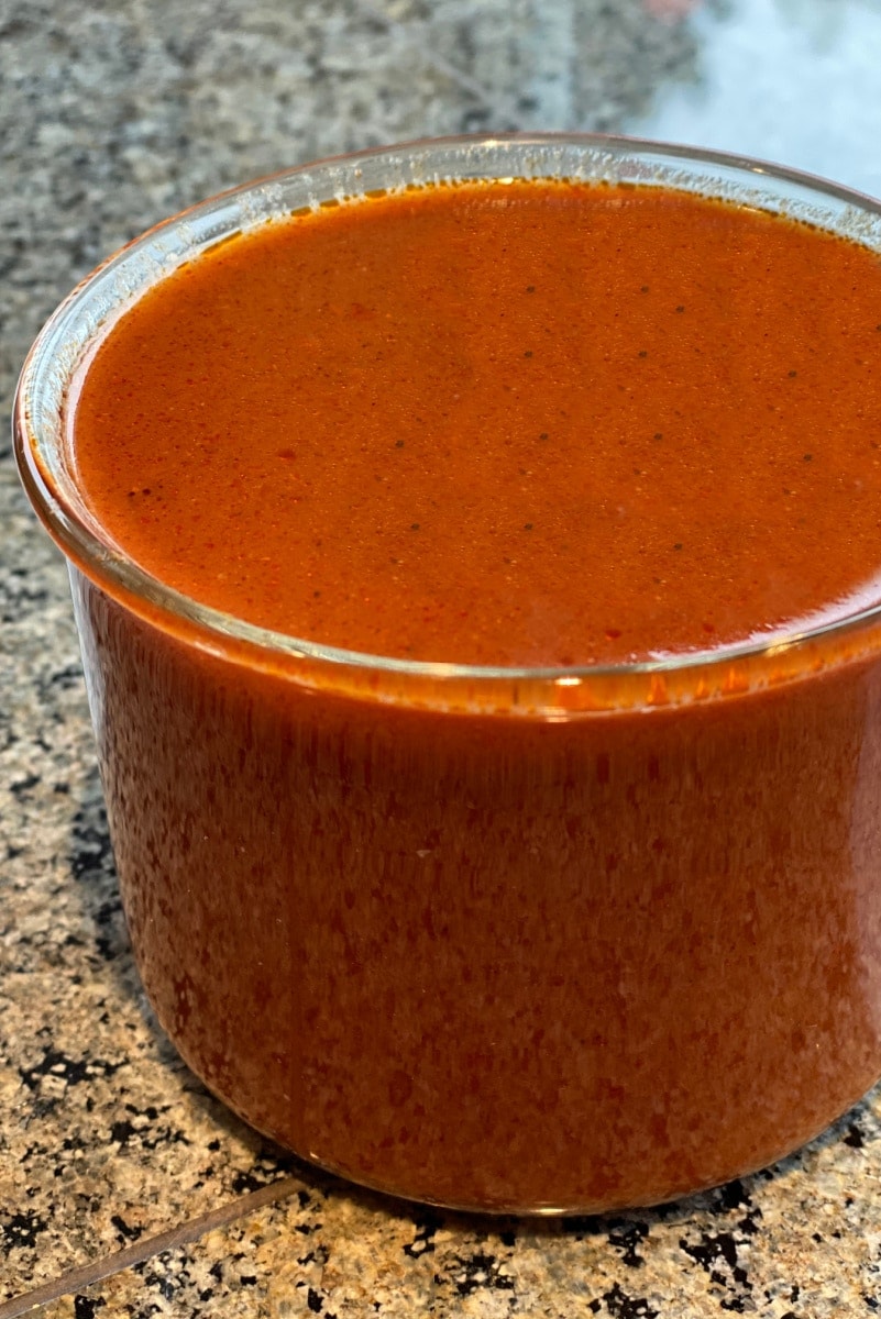 Enchilada sauce in glass jar on counter