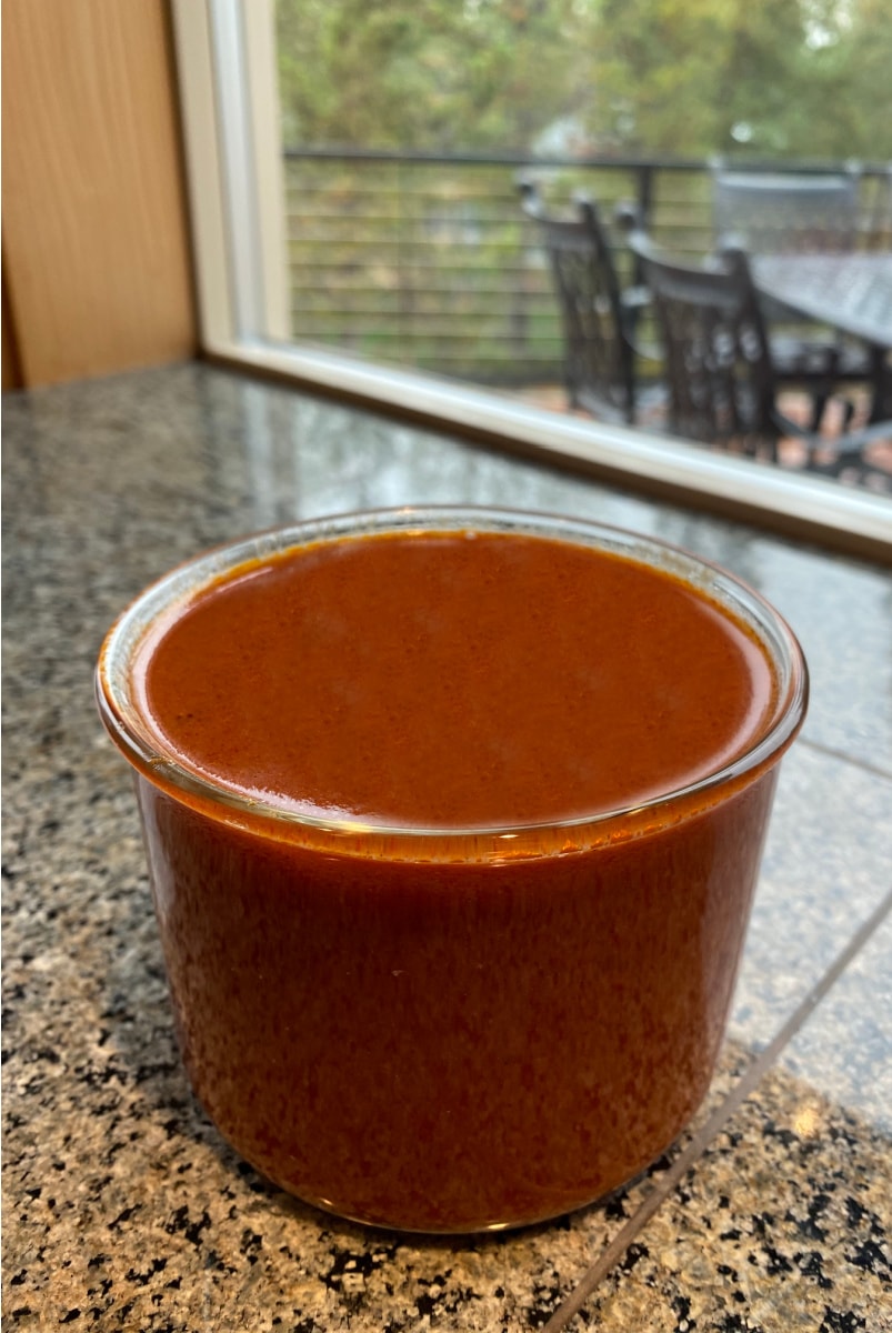 Best Enchilada Sauce recipe from RecipeGirl.com #best #enchilada #sauce #recipe #RecipeGirl #homemade enchilada sauce in glass container sitting on counter