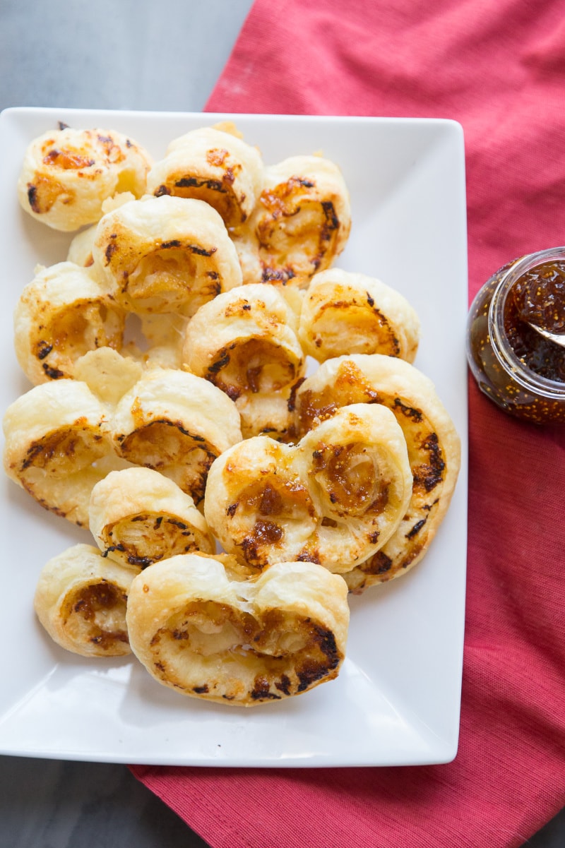 fig and gruyere palmiers on a white platter