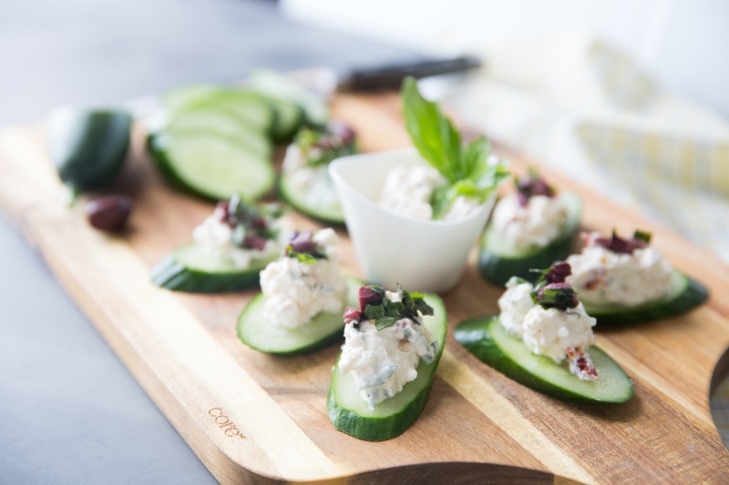 Greek Salad Bites recipe from RecipeGirl.com #greek #salad #bites #appetizer #recipe #RecipeGirl greek salad bites on a cutting board