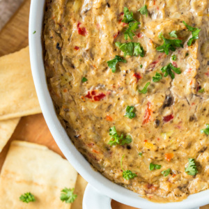 hot artichoke dip in a white baking dish