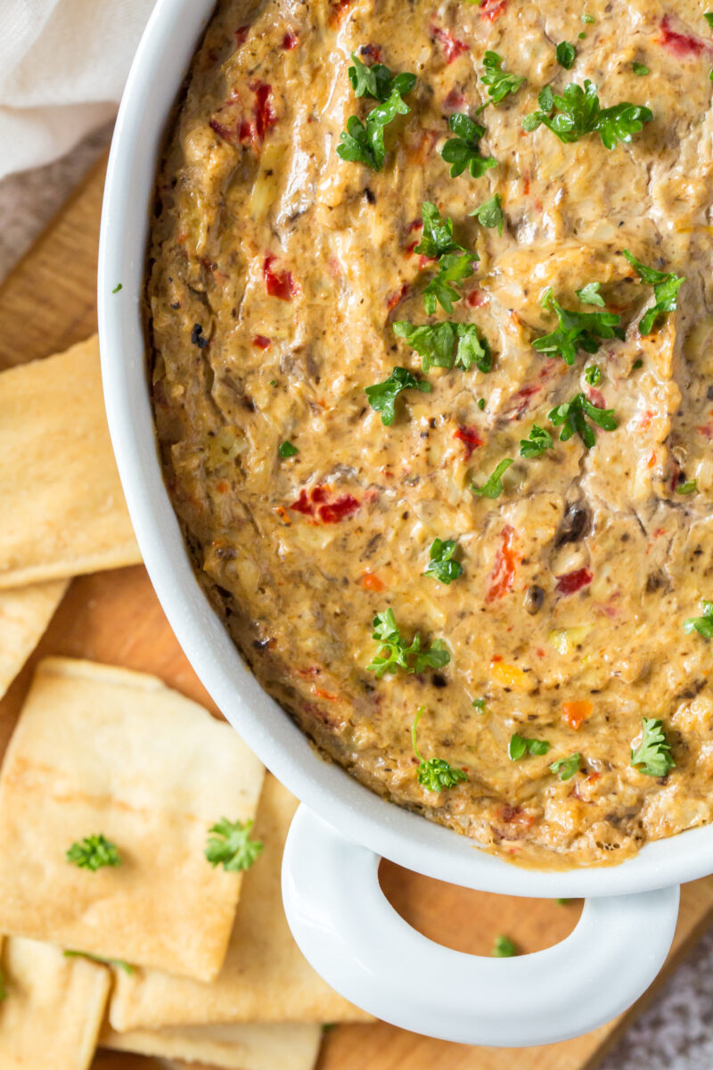 hot artichoke dip in a white baking dish