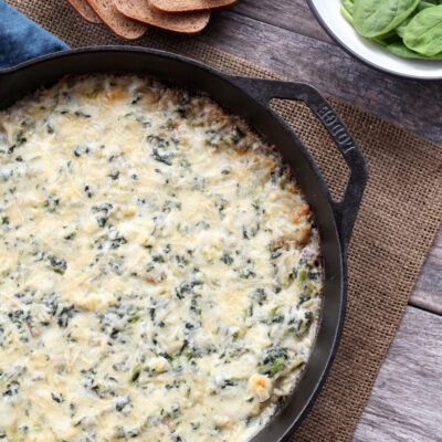 hot spinach artichoke dip in a cast iron skillet