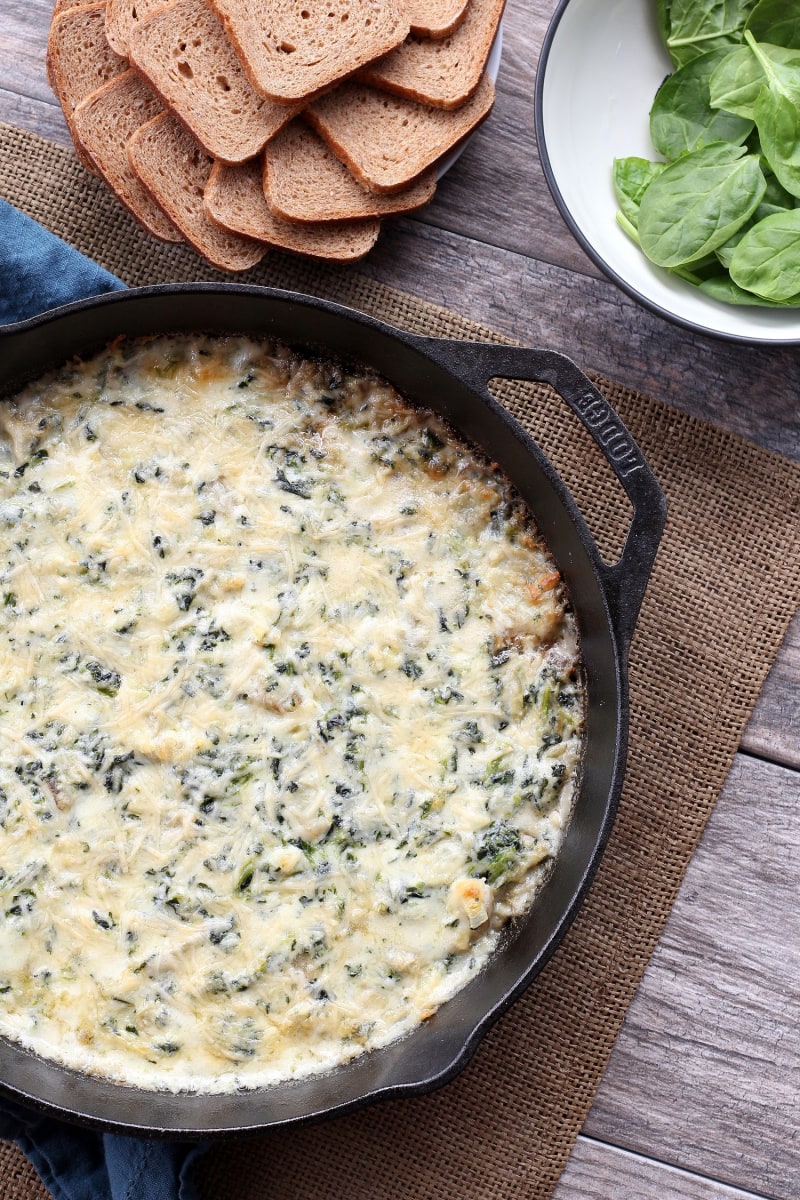 hot spinach artichoke dip in a cast iron skillet