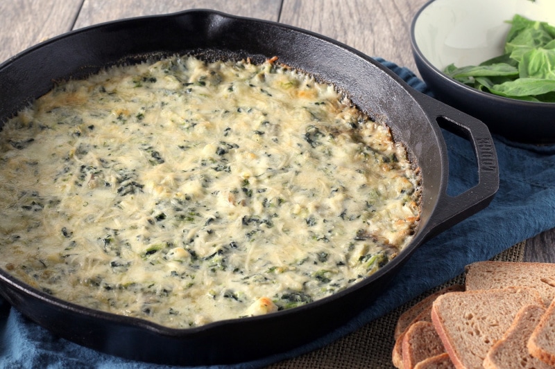 hot spinach artichoke dip in a skillet