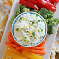 lemon chive cheese dip on display platter with veggies