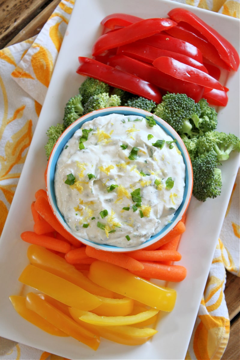 Lemon Chive Cheese Dip recipe from RecipeGirl.com #lemon #chive #cheese #dip #recipe #RecipeGirl lemon chive cheese dip on display platter with veggies