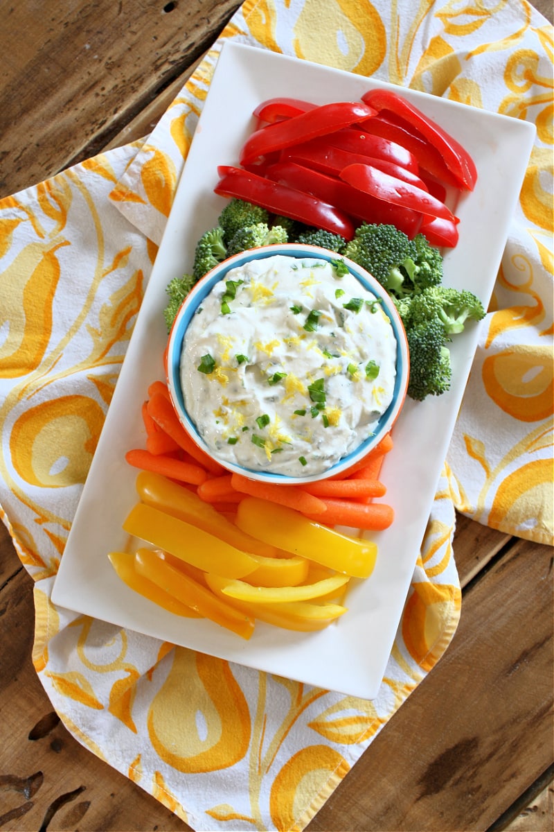 Lemon Chive Cheese Dip recipe from RecipeGirl.com #lemon #chive #cheese #dip #recipe #RecipeGirl lemon chive cheese dip in bowl surrounded by veggies on plate