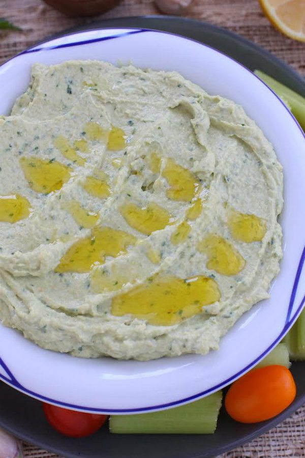 hummus with olive oil drizzled on top in white bowl