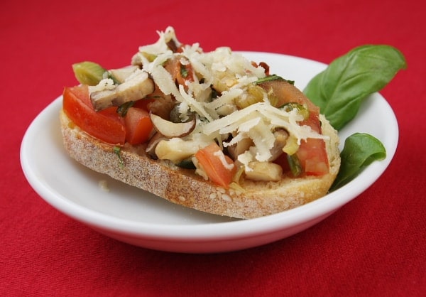 Piece of bruschetta on a white plate