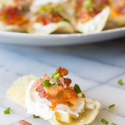 potato chips topped with goat cheese pepper jelly and bacon