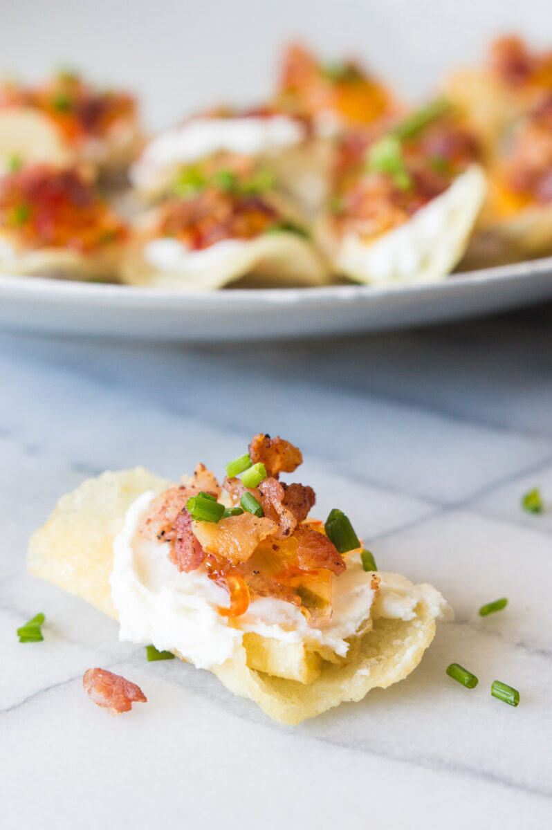 potato chips topped with goat cheese pepper jelly and bacon