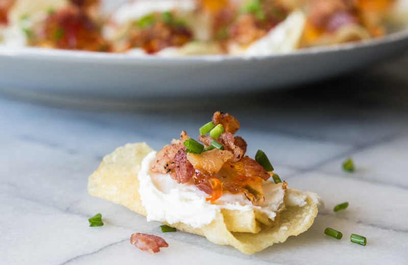 potato chip appetizer topped with goat cheese pepper jelly and bacon