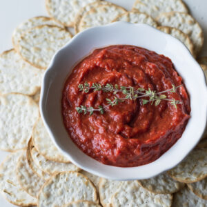 roasted sweet red pepper spread in white dish with crackers