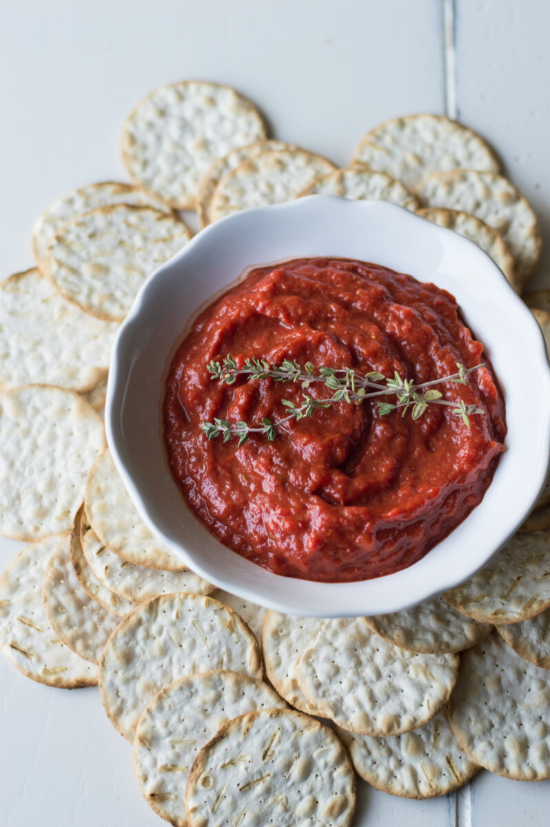 roasted sweet red pepper spread in white dish with crackers