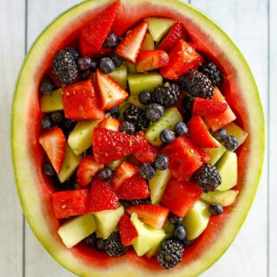 overhead shot of watermelon fruit bowl sitting on a white wood background surface