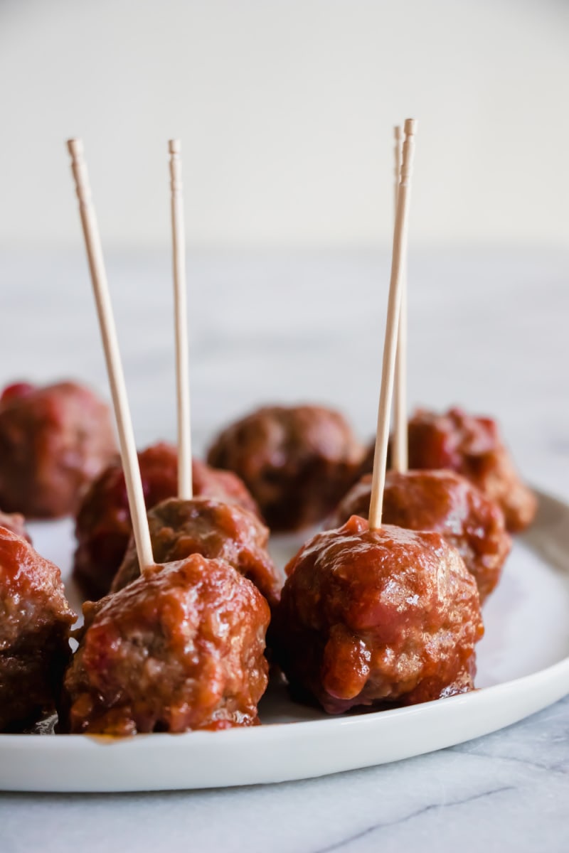 Sweet and Sour Meatballs appetizer recipe from RecipeGirl.com #sweet #sour #sweetandsour #meatballs #recipe #RecipeGirl sweet and sour meatballs on a plate with toothpicks
