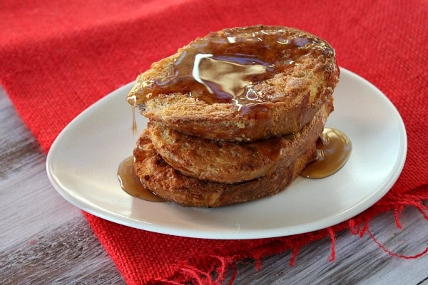 Three slices of french toast on a white plate