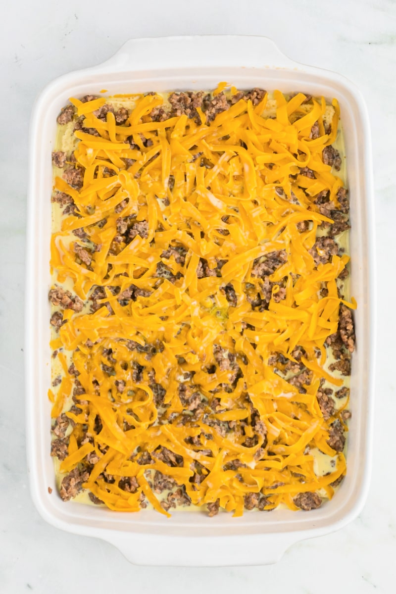 easy sausage breakfast casserole in white dish ready for oven