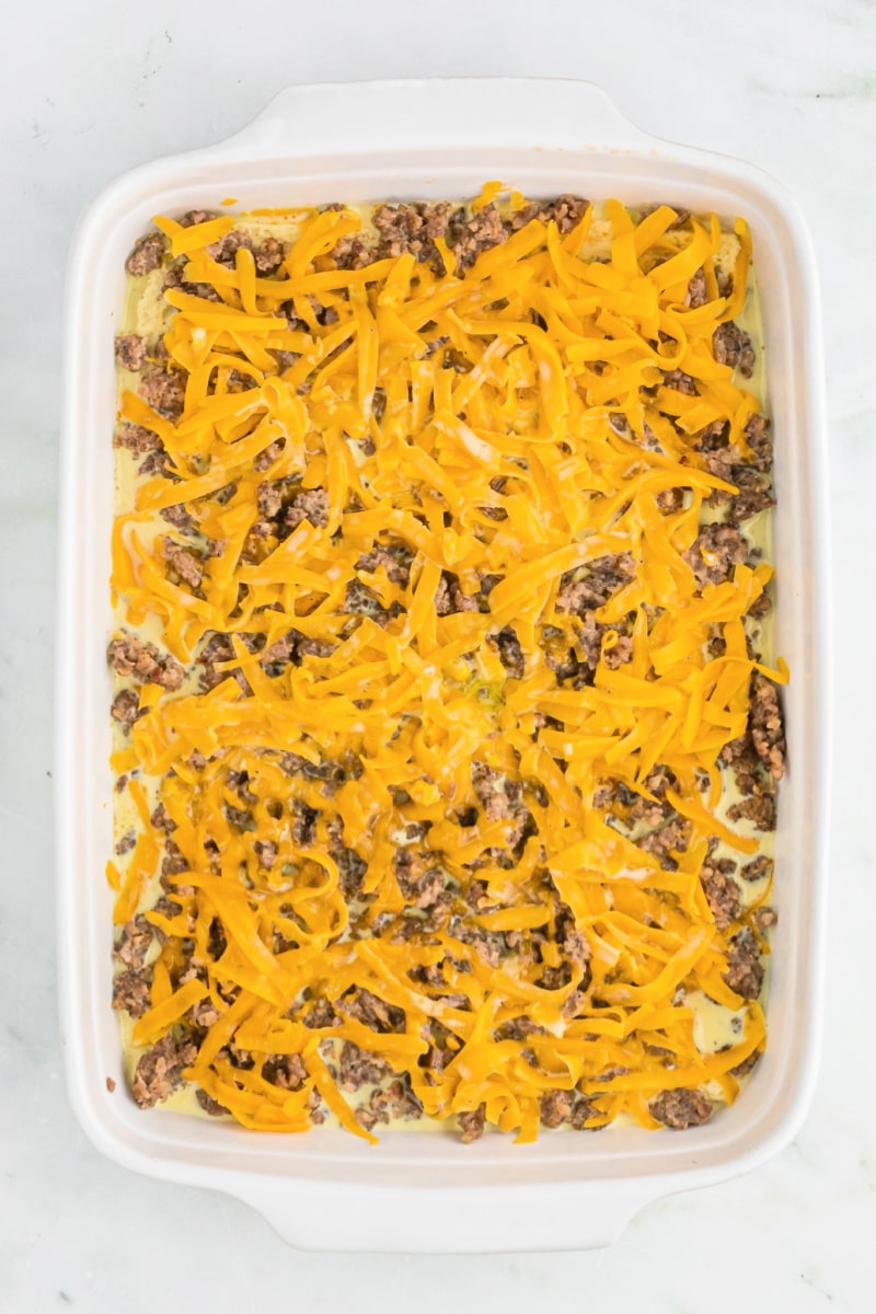 easy sausage breakfast casserole in white dish ready for oven