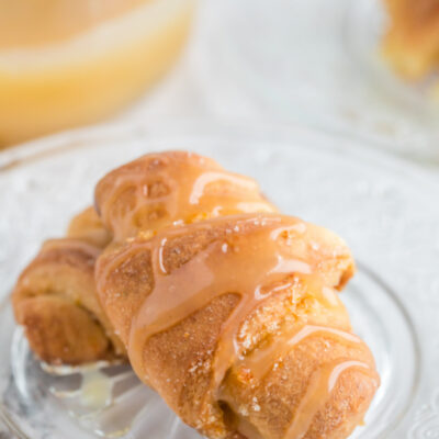 orange sticky buns on a plate with glaze