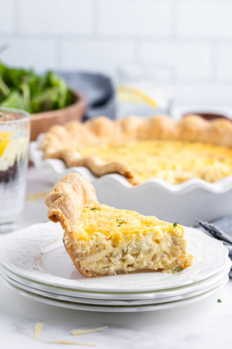 slice of swiss onion quiche on a plate