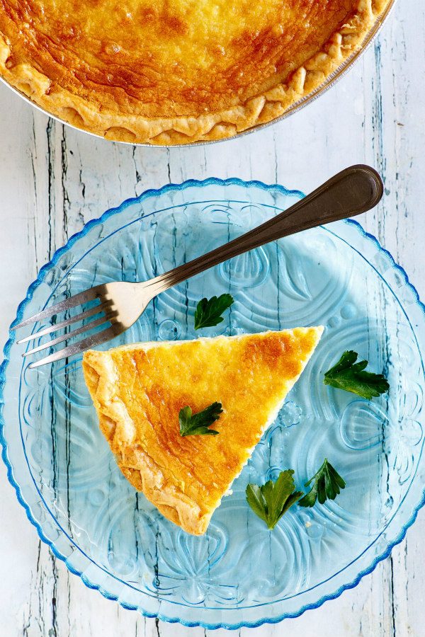 slice of quiche on a blue plate