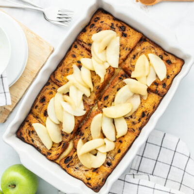 overnight apple stuffed french toast in a white casserole dish