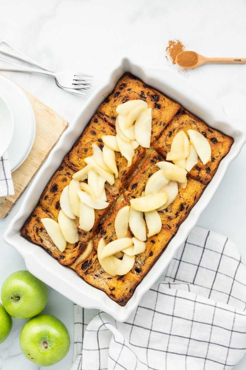 overnight apple stuffed french toast in a white casserole dish