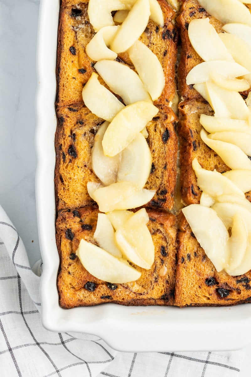 overhead shot of apple stuffed french toast in white casserole dish