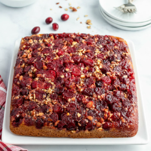 pumpkin cranberry upside down cake on white platter