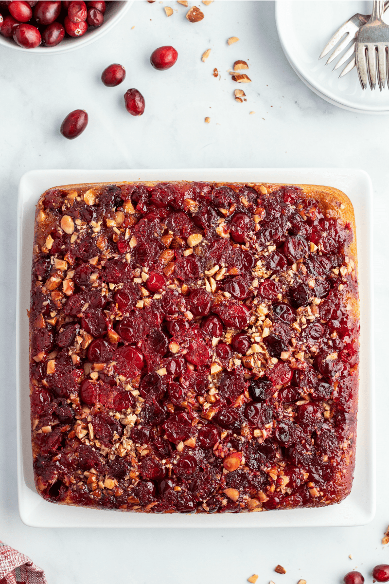 pumpkin cranberry upside down cake on white platter